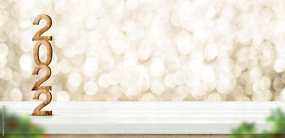 Aufkleber 2022 happy new year wood number (3d rendering) on white wood table with sparkling gold bokeh wall an