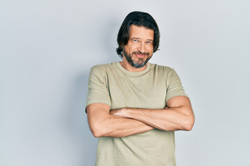 Middle age caucasian man wearing casual clothes happy face smiling with crossed arms looking at the camera. positive person.