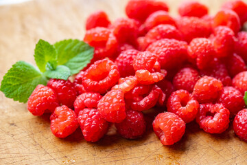 Fresh raspberries on wooden board.
