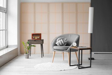 Interior of modern room with comfortable armchair