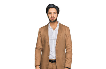 Young hispanic man wearing business clothes puffing cheeks with funny face. mouth inflated with...