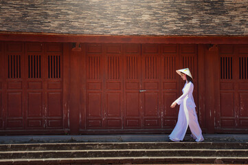 Asian woman Vietnam culture traditional dress on sandune during sunset ,traditional costume ,Muine Vietnam