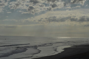 sun shining through clouds and beach landscape