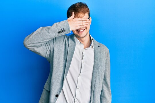 Young caucasian man wearing elegant clothes and glasses smiling and laughing with hand on face covering eyes for surprise. blind concept.