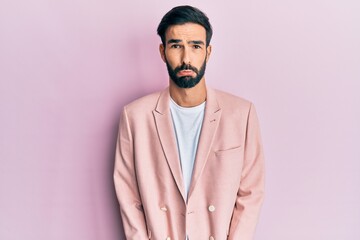 Young hispanic man wearing business jacket depressed and worry for distress, crying angry and afraid. sad expression.