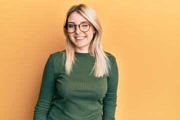 Young caucasian woman wearing casual clothes and glasses winking looking at the camera with sexy...