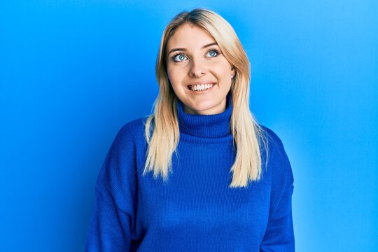 Young caucasian woman wearing casual winter sweater looking to side, relax profile pose with natural face and confident smile.