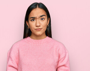 Fototapeta premium Young asian woman wearing casual winter sweater skeptic and nervous, frowning upset because of problem. negative person.