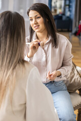 Professional female makeup artist applying cosmetics on model face use brush working at beauty salon