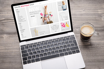Laptop with website of online fashion store on screen