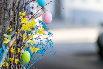 Fototapeta na wymiar Decorative Easter egg tree with many Easter eggs as ornamental celebration of christian season in April shows traditional cultural decoration as religious sign for springtime symbol for Christianity