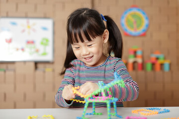 young girl playing creative blocks for homeshcooling