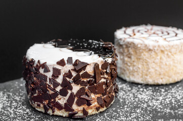 Small cakes on black background.