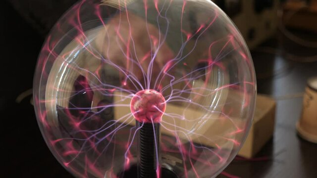 See-through sphere circling to demonstrate the electromagnetic field device  