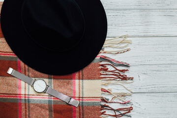 Flatley with black hat and autumn plaid scarf and watch.
