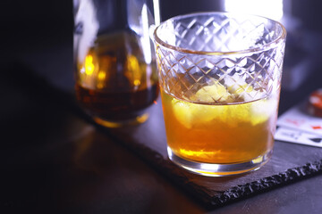 Gambling Card games for money. Texas Hold'em Poker. Cards in hand, playing chips, deck of cards of alcohol in a glass.