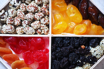 Nuts and dried fruits assortment on stone table top view.