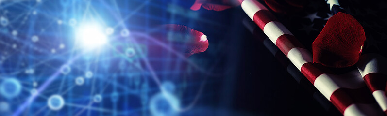 American flag and rose flower on the table. Symbol of the United States of America and red petals. Patriotism and memory.