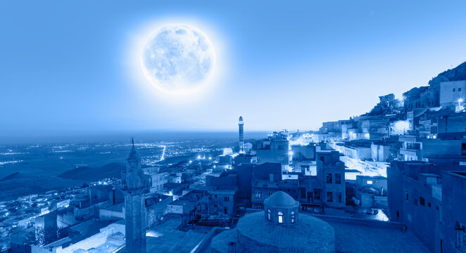 Mardin old town, spectacular Mesopotamia in the background with full blue moon - Mardin, Turkey "Elements of this image furnished by NASA"