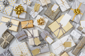 Top view different wrapped gift boxes on white marble multicolored various presents giving package