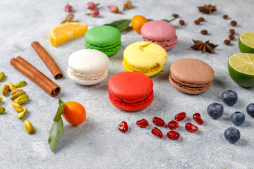 Various macaroons with pistachios,fruits,berries,coffee beans.