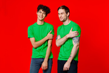 Fototapeta premium Cheerful friends in green t-shirts communication emotions isolated background