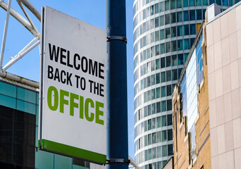 Welcome Back To The Office sign in a downtown city center