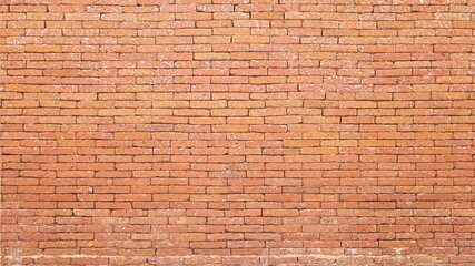 Fototapeta na wymiar A reddish brown laterite brick wall. Attractive antique red brick wall texture for background designs with copy space. Selective focus