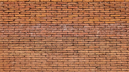 A reddish brown laterite brick wall. Attractive antique red brick wall texture for background...