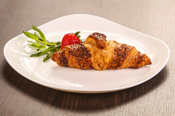 Sweet croissant in the plate