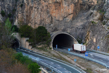 Refrigerated truck entering a tunnel dug into a rock face