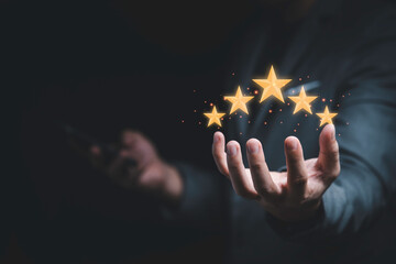 Businessman holding virtual five stars for customer feedback rating and evaluation concept.