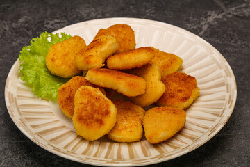 Fried chicken nuggets served salad leaves