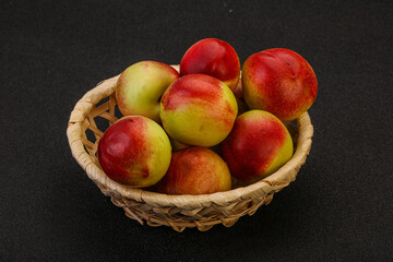 Sweet small nectarines in the basket