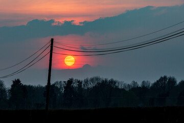 Telegraph wires silhouetted at sunset
