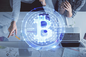 Double exposure of man and woman working together and crypto theme hologram drawing. Computer...