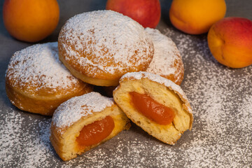 Freshly cooked Apricot jam doughnuts, referred to as jelly doughnuts, donuts in the US, The doughnuts have been fried, injected with a generous amount of jelly, jam and then dipped in caster sugar