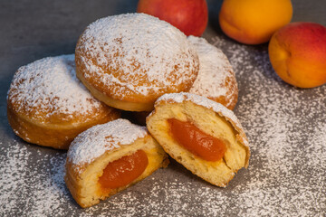 Freshly cooked Apricot jam doughnuts, referred to as jelly doughnuts, donuts in the US, The doughnuts have been fried, injected with a generous amount of jelly, jam and then dipped in caster sugar