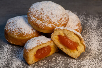 Freshly cooked Apricot jam doughnuts, referred to as jelly doughnuts, donuts in the US, The doughnuts have been fried, injected with a generous amount of jelly, jam and then dipped in caster sugar