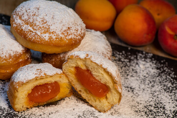 Freshly cooked Apricot jam doughnuts, referred to as jelly doughnuts, donuts in the US, The doughnuts have been fried, injected with a generous amount of jelly, jam and then dipped in caster sugar