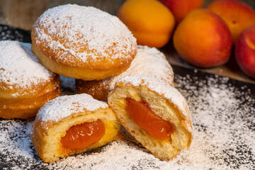 Freshly cooked Apricot jam doughnuts, referred to as jelly doughnuts, donuts in the US, The doughnuts have been fried, injected with a generous amount of jelly, jam and then dipped in caster sugar
