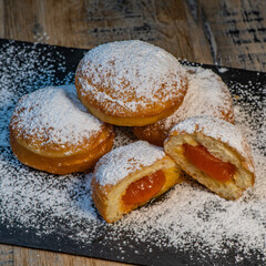 Freshly cooked Apricot jam doughnuts, referred to as jelly doughnuts, donuts in the US, The doughnuts have been fried, injected with a generous amount of jelly, jam and then dipped in caster sugar
