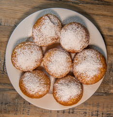 Freshly cooked Apricot jam doughnuts, referred to as jelly doughnuts, donuts in the US, The doughnuts have been fried, injected with a generous amount of jelly, jam and then dipped in caster sugar