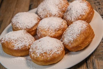 Freshly cooked Apricot jam doughnuts, referred to as jelly doughnuts, donuts in the US, The doughnuts have been fried, injected with a generous amount of jelly, jam and then dipped in caster sugar