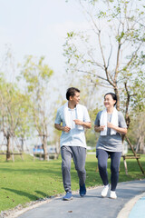 Fototapeta premium Couple doing exercising by running in the garden. Happy senior couple after exercising.