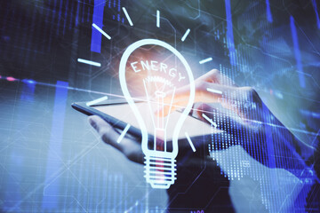 Double exposure of light bulb hologram and woman holding and using a mobile device. Idea concept.