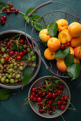Overhead view of fresh summer fruits on reen surface