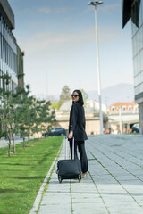 Busiensswoman is waiting with her traveling bag