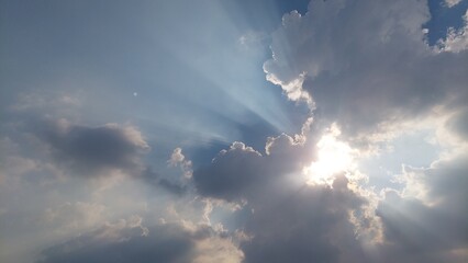 Naklejka na ściany i meble sunshine touch clouds on blue sky