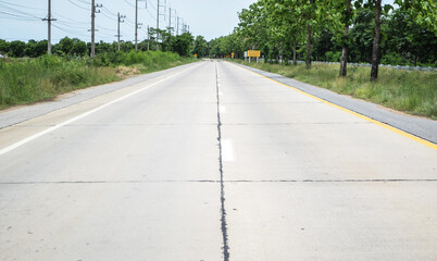 Center of concrete pavement road with longitudinal joint, construction joint,traffic lane line and traffic island.Empty concrete road.